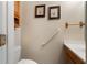 Bathroom featuring a sink and vanity, framed artwork, and grab bar at 4895 Cr 134B, Wildwood, FL 34785