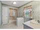 Bathroom with shower, vanity, and window at 4895 Cr 134B, Wildwood, FL 34785