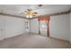 Spacious bedroom featuring carpet flooring, ceiling fan, and a window at 4895 Cr 134B, Wildwood, FL 34785