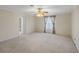 Bedroom featuring carpet, ceiling fan, and decorated window at 4895 Cr 134B, Wildwood, FL 34785