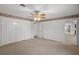 Bedroom featuring carpet flooring, ceiling fan, closet, and a doorway at 4895 Cr 134B, Wildwood, FL 34785