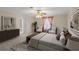 Relaxing bedroom featuring a neutral palette, sitting area, and ensuite access at 4895 Cr 134B, Wildwood, FL 34785