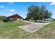 Sprawling property with a brick home, mature trees, and an expansive driveway at 4895 Cr 134B, Wildwood, FL 34785