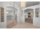 Open foyer featuring tile flooring, archways, and views into the living room and dining area with elegant lighting at 4895 Cr 134B, Wildwood, FL 34785