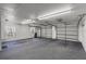 Spacious three car garage with ample lighting and neutral interior at 4895 Cr 134B, Wildwood, FL 34785