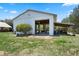 View of the open garage with a large concrete pad and a covered storage area on the side at 4895 Cr 134B, Wildwood, FL 34785