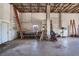 View of the garage interior with workbench, storage shelving, and ample workspace at 4895 Cr 134B, Wildwood, FL 34785