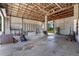 Open garage featuring shelving, workspace, and plentiful storage for an organized utility space at 4895 Cr 134B, Wildwood, FL 34785