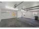 Interior view of a spacious garage with bright lighting and multiple access points at 4895 Cr 134B, Wildwood, FL 34785