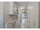 Hallway with cabinets, light tile flooring, and neutral paint at 4895 Cr 134B, Wildwood, FL 34785