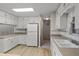 Kitchen featuring white cabinetry, and standard appliances with light counter tops at 4895 Cr 134B, Wildwood, FL 34785