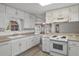 Bright white kitchen with ample cabinet space and modern appliances at 4895 Cr 134B, Wildwood, FL 34785