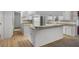 Bright kitchen featuring a breakfast bar, white cabinets, and modern appliances, designed for functionality and style at 4895 Cr 134B, Wildwood, FL 34785