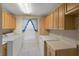 Laundry room with washer, dryer, storage cabinets, and a window at 4895 Cr 134B, Wildwood, FL 34785