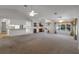Open-concept living area combining living, dining, and kitchen spaces with natural light, ideal for modern living at 4895 Cr 134B, Wildwood, FL 34785
