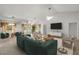 Spacious living room with neutral carpet, large windows, and comfortable seating arrangement at 4895 Cr 134B, Wildwood, FL 34785