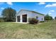 Large outbuilding with two bays surrounded by a well-kept lawn and mature trees at 4895 Cr 134B, Wildwood, FL 34785