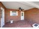 Spacious brick patio with brick walls, a ceiling fan, and convenient access points at 4895 Cr 134B, Wildwood, FL 34785
