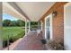 Charming brick porch with brick flooring, cozy seating, and an inviting entrance at 4895 Cr 134B, Wildwood, FL 34785