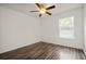 Bedroom featuring laminate flooring, ceiling fan, and window at 5160 Wood Ridge Ct, Ocoee, FL 34761
