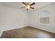 Cozy bedroom with laminate flooring, a ceiling fan, and a window at 5160 Wood Ridge Ct, Ocoee, FL 34761