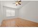 Bedroom with laminate flooring, ceiling fan, and natural light from the window at 5160 Wood Ridge Ct, Ocoee, FL 34761