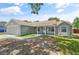 Inviting single-story home showcasing a covered porch and fresh landscaping at 5160 Wood Ridge Ct, Ocoee, FL 34761