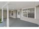The home's covered porch has white columns, gray brick base, neutral siding and a decorative door at 5160 Wood Ridge Ct, Ocoee, FL 34761