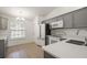 Modern kitchen boasts gray cabinets, white appliances, and stylish countertops at 5160 Wood Ridge Ct, Ocoee, FL 34761