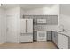 Well-equipped kitchen with gray cabinetry and modern white appliances at 5160 Wood Ridge Ct, Ocoee, FL 34761