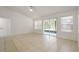 Bright living room with tile flooring, large windows, and sliding glass doors to the backyard at 5160 Wood Ridge Ct, Ocoee, FL 34761