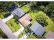 An aerial view shows a well-maintained property with a lush green lawn and mature trees, conveying a sense of suburban tranquility at 5216 Sunrise Blvd, Orlando, FL 32803