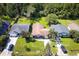 Aerial view of neighborhood showing 3 homes with mature trees and lush lawns at 5216 Sunrise Blvd, Orlando, FL 32803