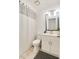 Bathroom featuring white cabinets and vanity, shower with curtain, decorative mirror and updated lighting at 5216 Sunrise Blvd, Orlando, FL 32803