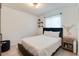 Bedroom featuring a blue headboard, white bedding, and a single window at 5216 Sunrise Blvd, Orlando, FL 32803