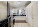 Modern kitchen featuring white cabinetry, stainless steel appliances, and a view of the backyard at 5216 Sunrise Blvd, Orlando, FL 32803