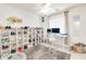 Well-lit office space features a custom shoe shelf and white work desk with a large window at 5216 Sunrise Blvd, Orlando, FL 32803