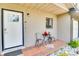 Cozy front porch with a seating area, a decorative cardinal, and a view of the front yard at 5216 Sunrise Blvd, Orlando, FL 32803
