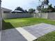 Spacious backyard featuring a well-maintained lawn, a paved patio area, and a privacy fence, ideal for outdoor living at 5350 Pine Lilly Dr, St Cloud, FL 34771