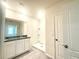 Bathroom featuring a double vanity with granite countertop, mirror, and a step-in shower at 5350 Pine Lilly Dr, St Cloud, FL 34771