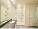 Bathroom with a single sink, granite countertop, step-in shower with shelving, and tiled floor at 5350 Pine Lilly Dr, St Cloud, FL 34771