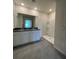 Modern bathroom with double vanity, granite countertop, large mirror and walk in shower at 5350 Pine Lilly Dr, St Cloud, FL 34771