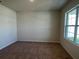 Neutral bedroom featuring carpet flooring and a large window allowing plenty of natural light at 5350 Pine Lilly Dr, St Cloud, FL 34771