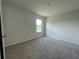 This bedroom includes plush carpeting and a sunlit window for a comfortable and inviting space at 5350 Pine Lilly Dr, St Cloud, FL 34771
