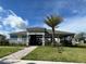 Clubhouse with covered seating, palm trees, and manicured landscaping, perfect for community gatherings at 5350 Pine Lilly Dr, St Cloud, FL 34771