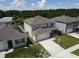 Two-story home features an attached two-car garage and manicured front lawn at 5350 Pine Lilly Dr, St Cloud, FL 34771