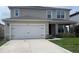 Two-story home featuring an attached two-car garage and a covered front porch at 5350 Pine Lilly Dr, St Cloud, FL 34771