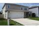 Two-story house with an attached two-car garage and a covered front porch at 5350 Pine Lilly Dr, St Cloud, FL 34771
