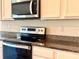 Bright kitchen showcasing stainless steel microwave and oven at 5350 Pine Lilly Dr, St Cloud, FL 34771