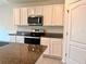 Updated kitchen featuring white cabinets, granite counters, and stainless steel appliances at 5350 Pine Lilly Dr, St Cloud, FL 34771